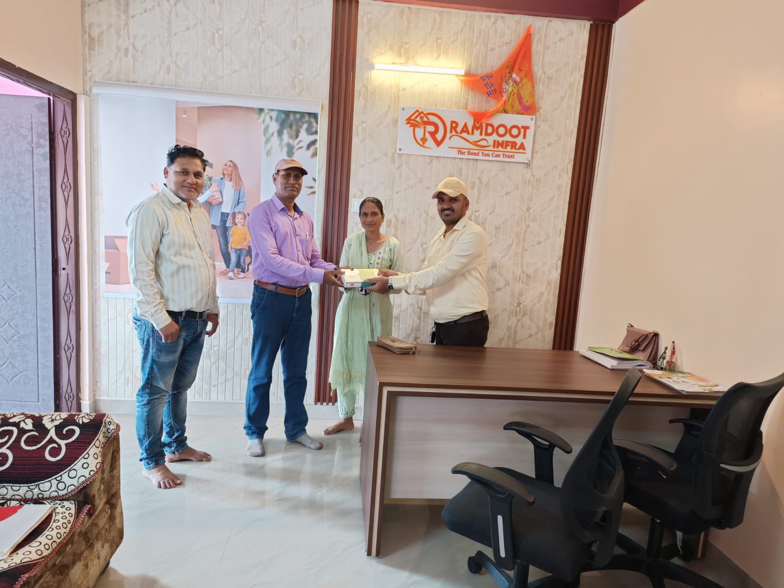 Satisfied home buyers receiving property documents Ramdoot Infra