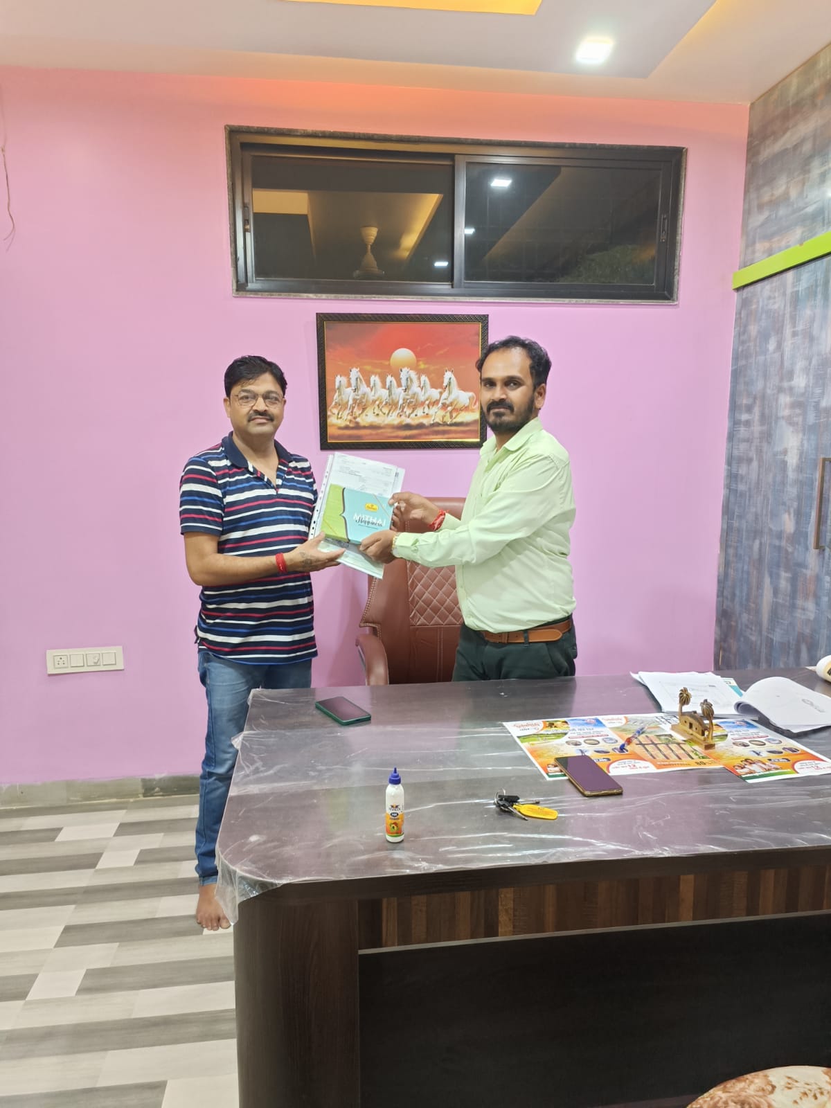 Satisfied home buyers receiving property documents Ramdoot Infra