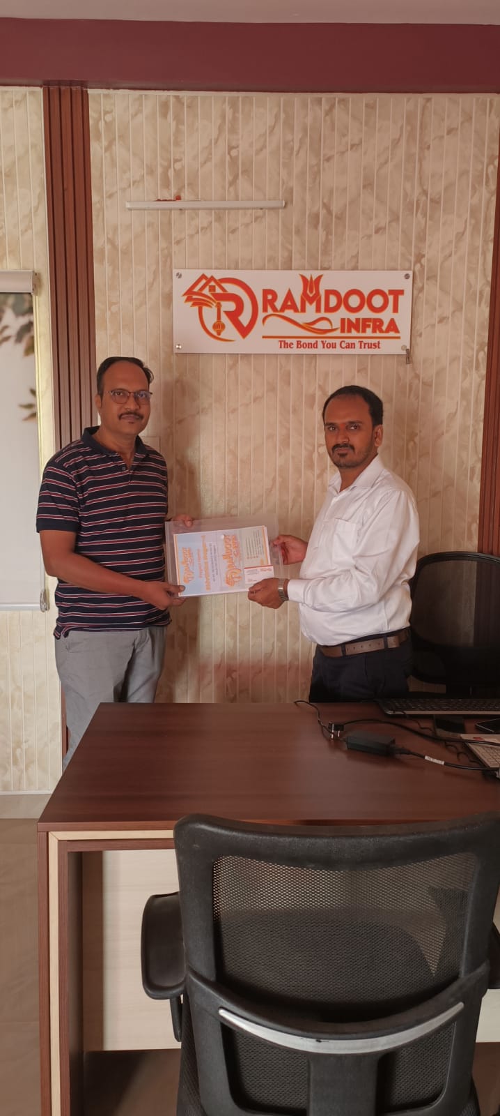 Satisfied home buyers receiving property documents Ramdoot Infra