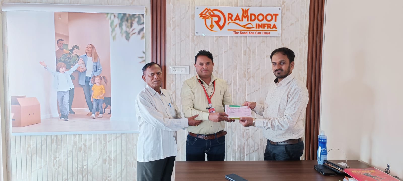 Satisfied home buyers receiving property documents Ramdoot Infra