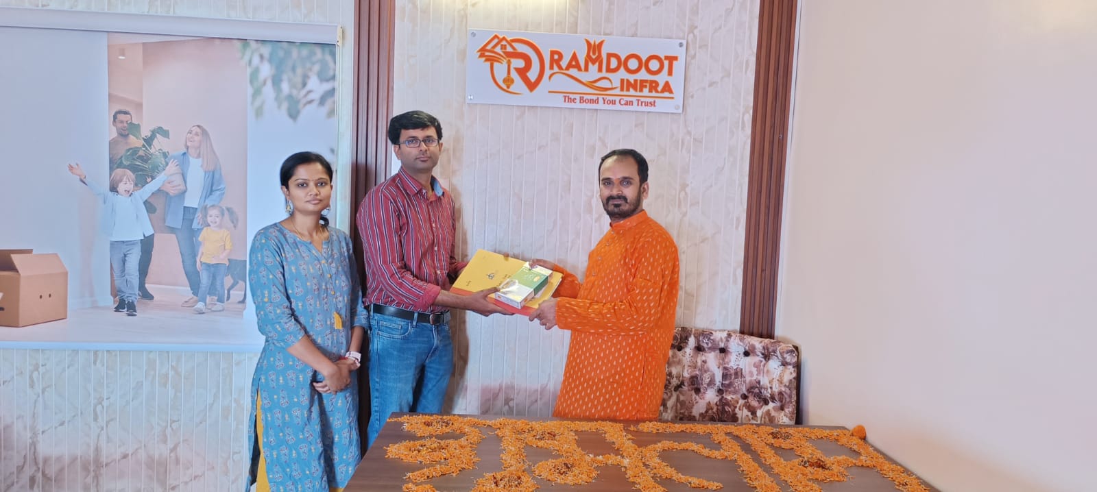Satisfied home buyers receiving property documents Ramdoot Infra
